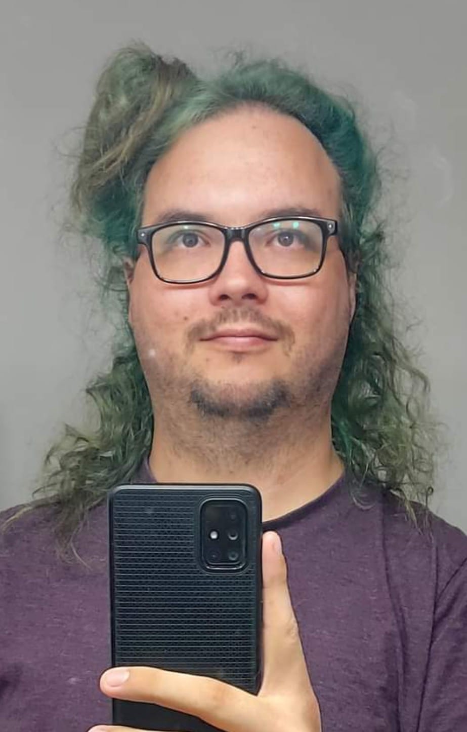 A man with long green hair and no beard is taking a mirror selfie, Photo 3